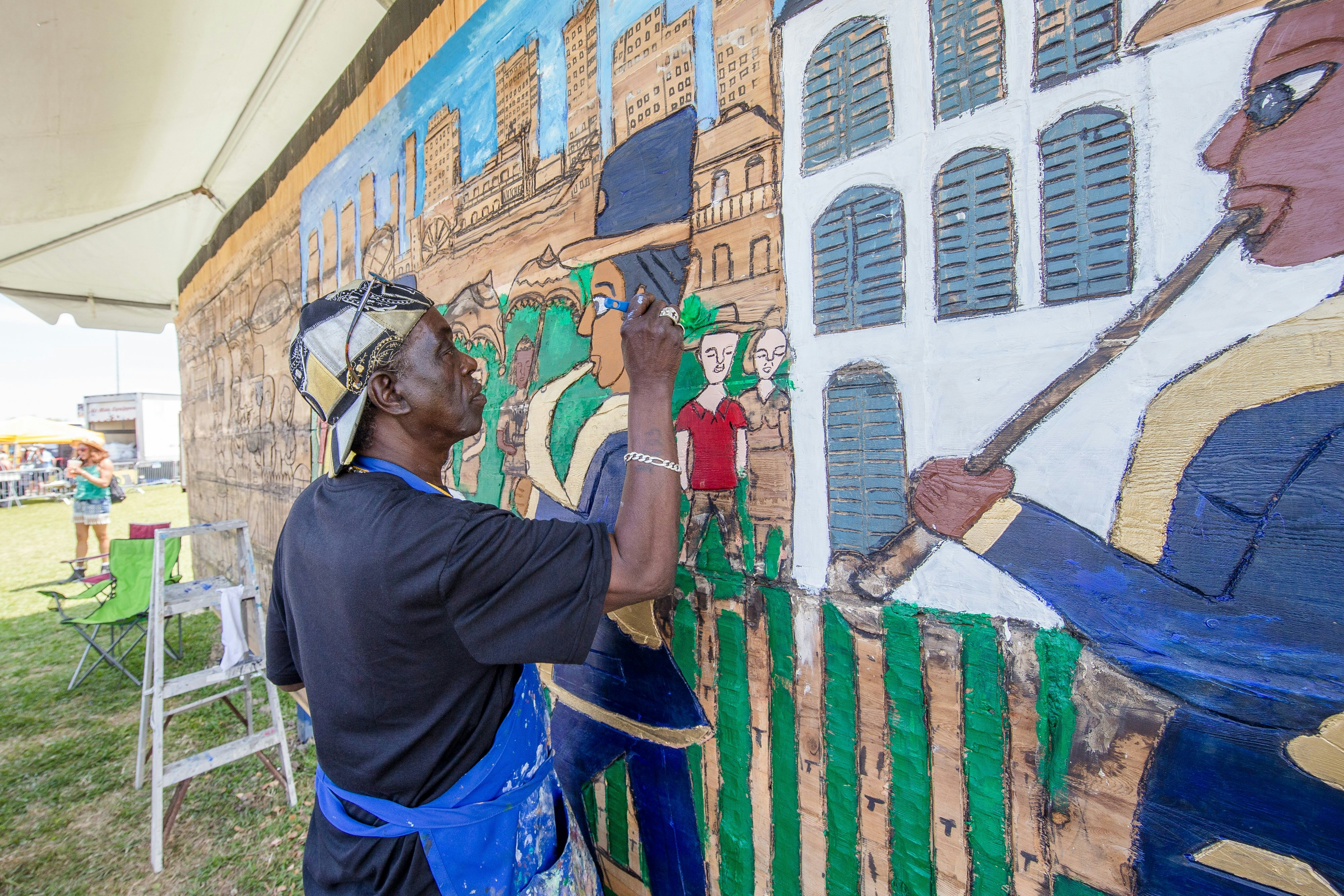 NEW ORLEANS, LA - APRIL 28: Artist Charles Gillam works on a wood carving at the New Orleans Jazz & Heritage Festival at the Fair Grounds Race Course on April 28, 2018 in New Orleans, Louisiana.  (Photo by Josh Brasted/WireImage)