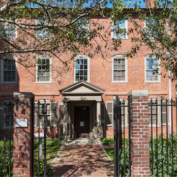 Portland, ME, USA - September 17, 2013: Wadsworth-Longfellow House, Portland, Maine, New England, USA. The Wadsworth-Longfellow House is Maine's first house museum. Henry Wadsworth Longfellow was a commanding figure in the cultural life of nineteenth-century America. Born in Portland, Maine, in 1807, he became a national literary figure by the 1850s, and a world- famous personality by the time of his death in 1882. Red brick colonial house, gates, green front yard with trees, bushes and grass and blue sky are in the image.
Longfellow House