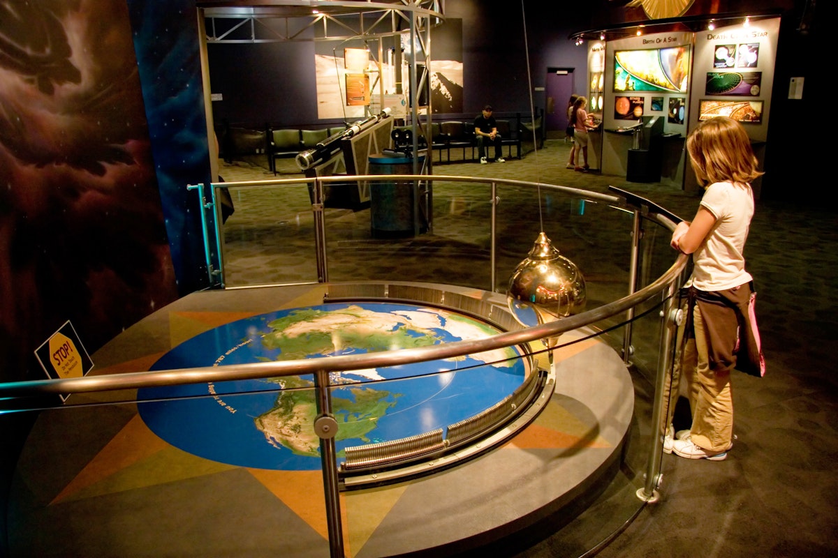 A girl watches the pendulum exhibit at Clark Planetarium at the Gateway Center in downtown Salt Lake City, Utah USA. (Photo by: Universal Images Group via Getty Images)