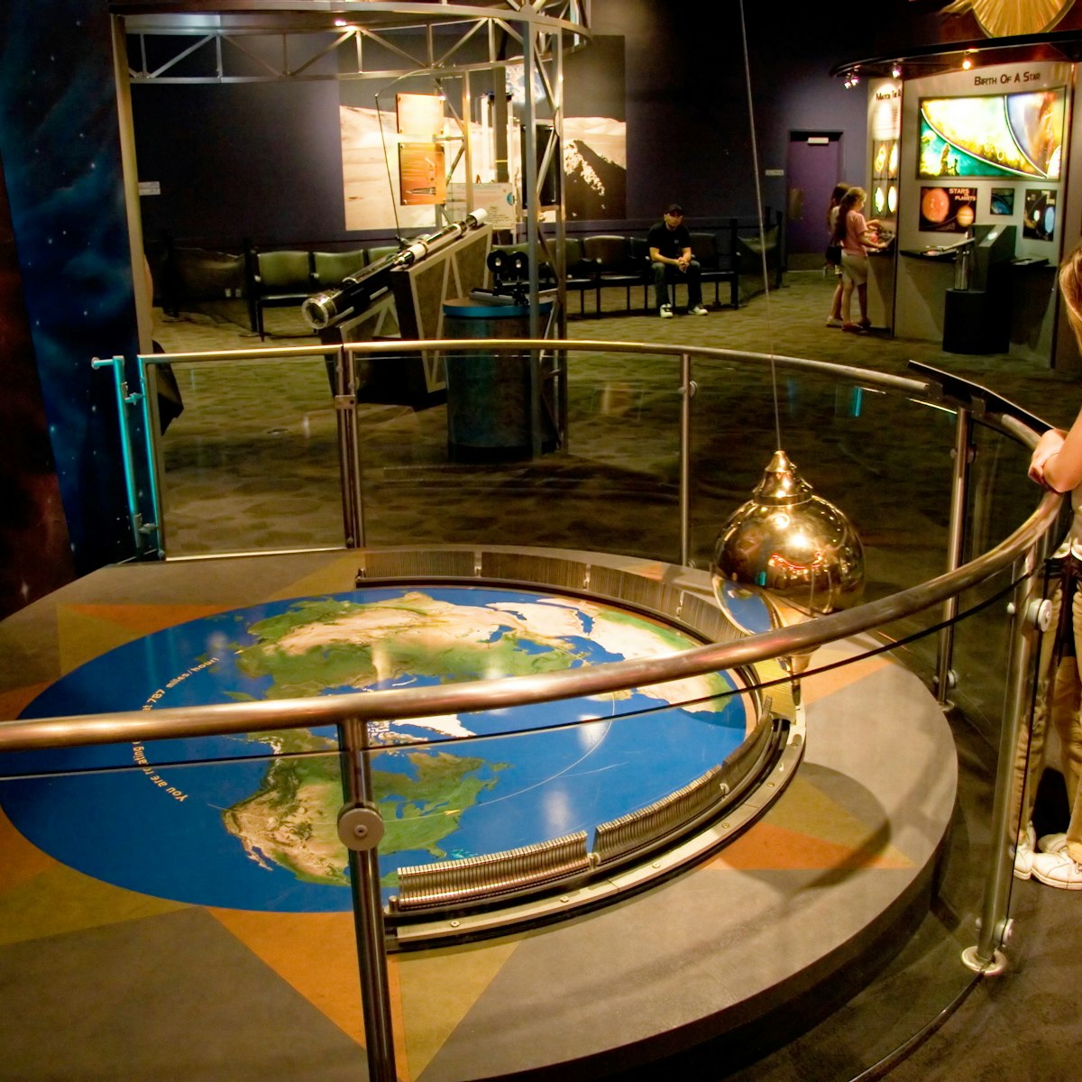 A girl watches the pendulum exhibit at Clark Planetarium at the Gateway Center in downtown Salt Lake City, Utah USA. (Photo by: Universal Images Group via Getty Images)
