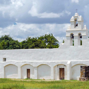 This landmark image depicts Mission San Juan Capistrano in San Antonio, Texas. This UNESCO World Heritage Site was established in 1731 by Spanish colonist along the banks of the San Antonio River.