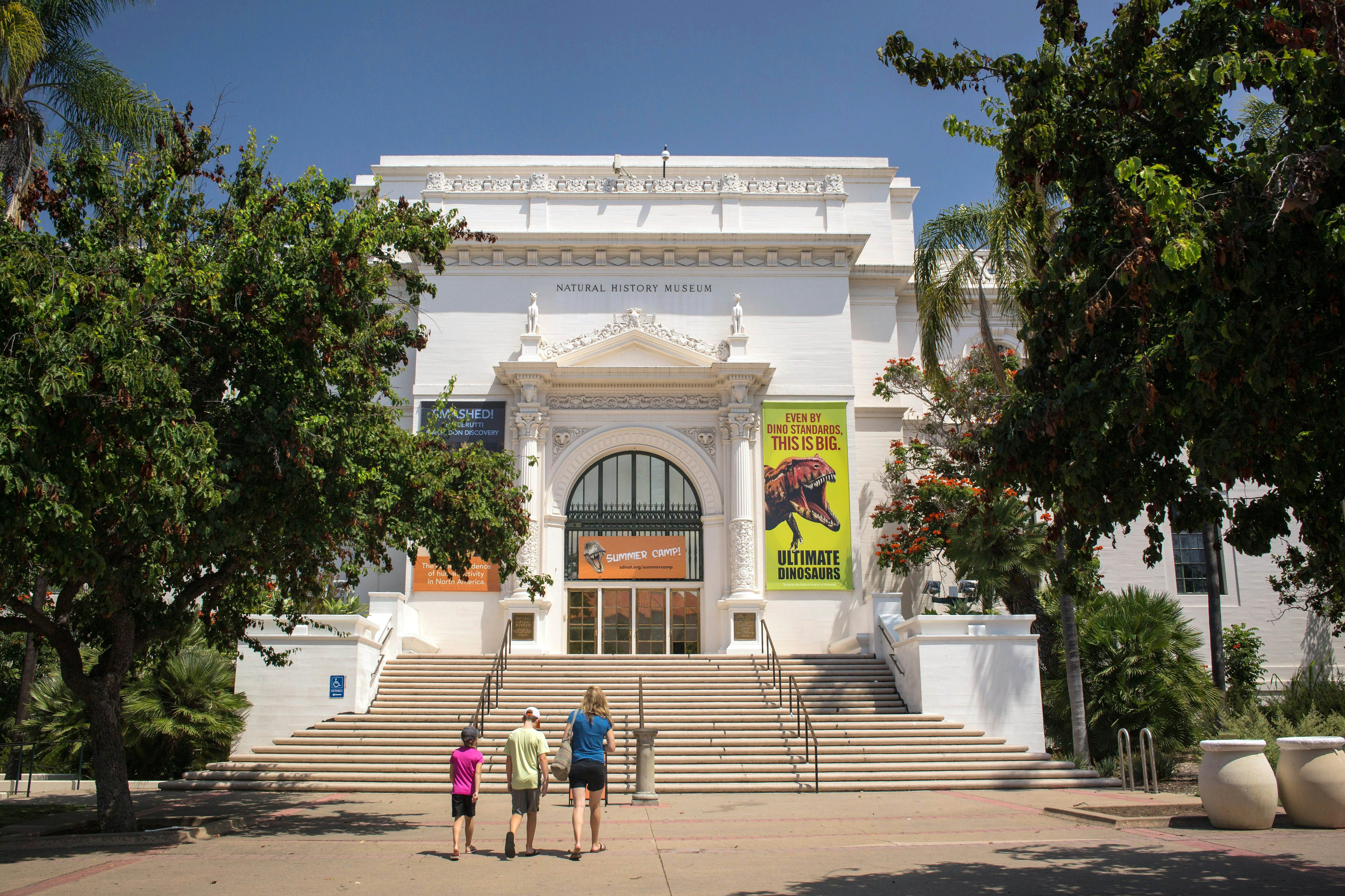 San Diego, California: Horizontal view of a mother and her two children going to the Natural History Museum entrance, Balboa Park