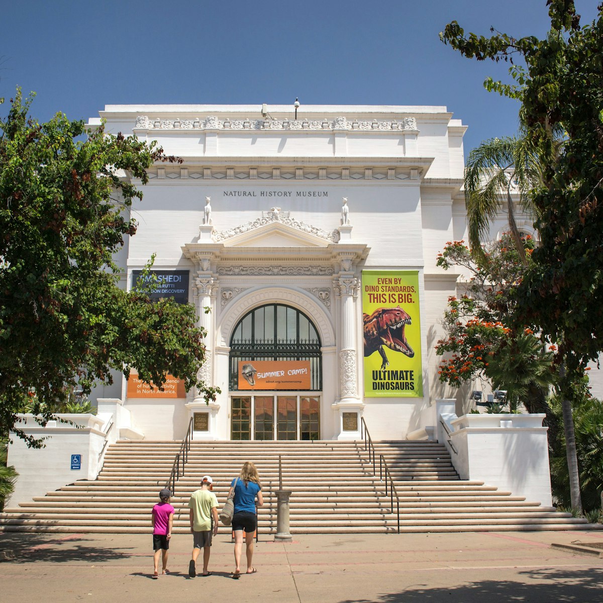 San Diego, California: Horizontal view of a mother and her two children going to the Natural History Museum entrance, Balboa Park