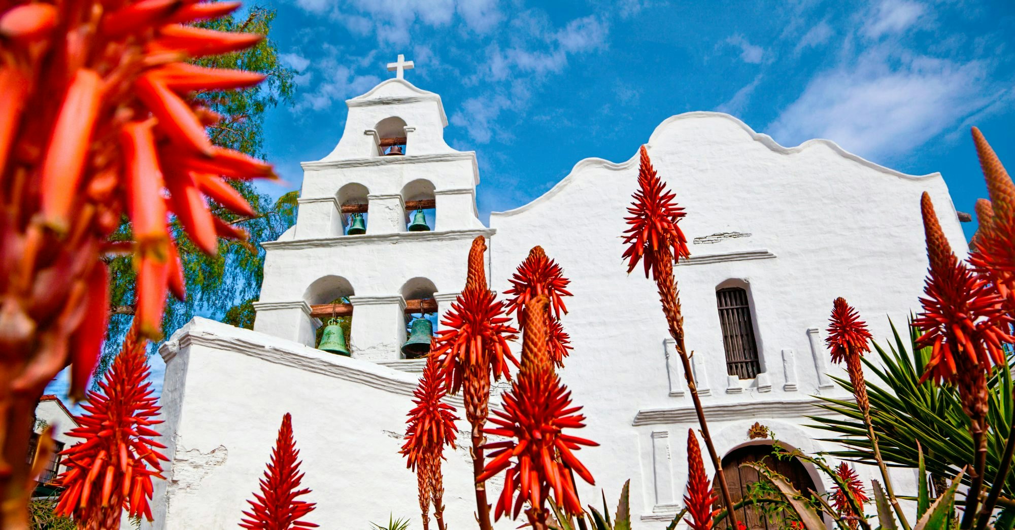 Mission Basilica San Diego de Alcala. - stock photo

California's first mission.  Aloe plants blooming in foreground.