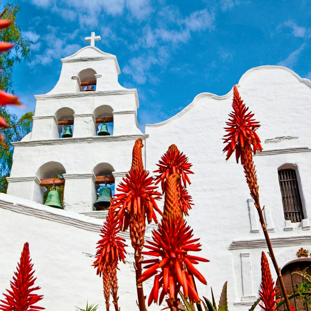 Mission Basilica San Diego de Alcala. - stock photo
California's first mission.  Aloe plants blooming in foreground.