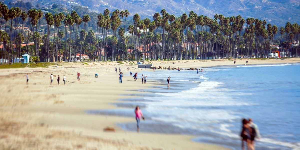 Beautiful view of Santa Barbara ocean front walk, with beach and marina, palms and mountains, Santa Ynez mountains and Pacific Ocean, Santa Barbara  county, California, United States, summer sunny day