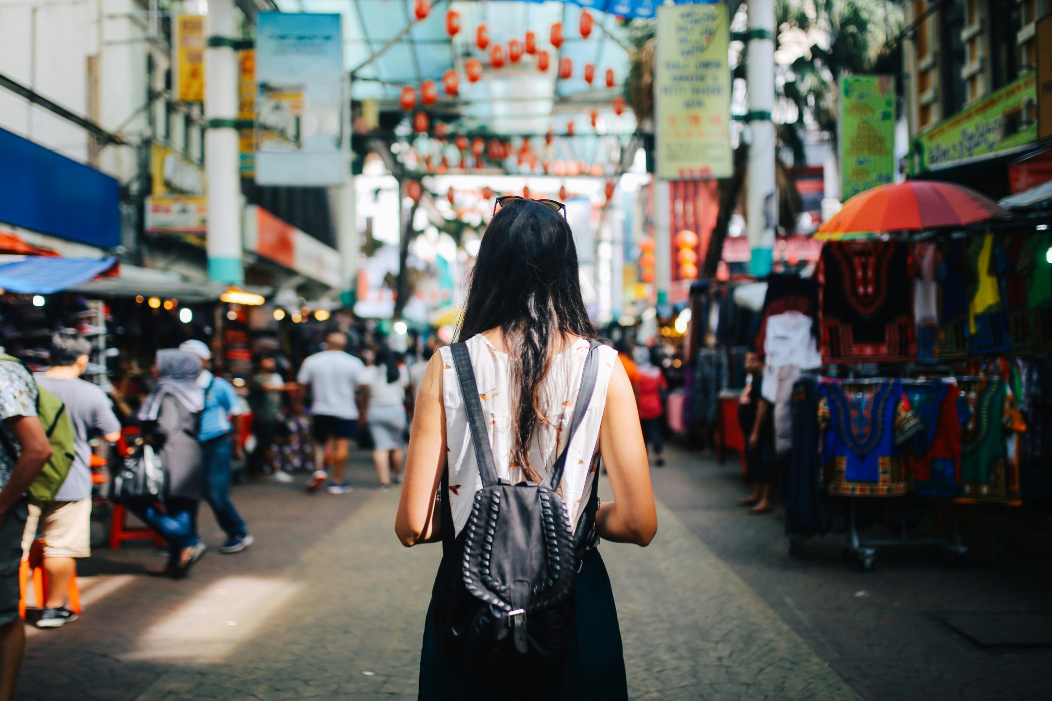 Young traveler woman walking through the stalls in Chinatown district of Kuala Lumpur, Malaysia