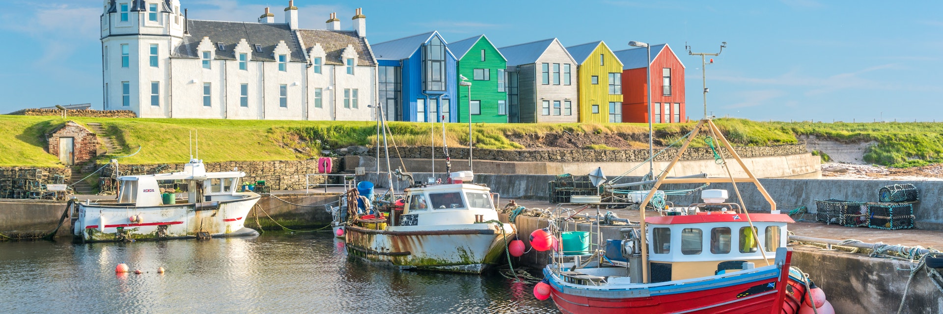 The colorful buildings of John O'Groats in a sunny afternoon, Caithness county, Scotland.