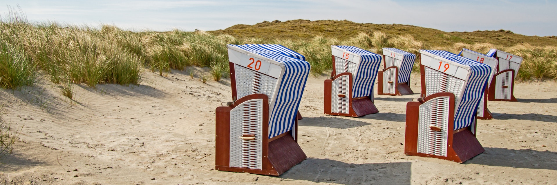 View of beach chairs in the dunes of Noederney, island in East Frisia.