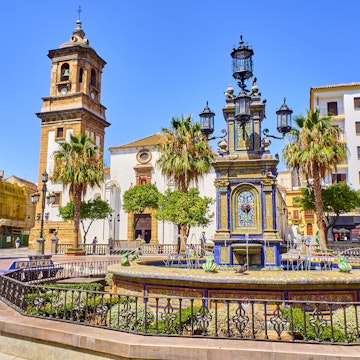 Algeciras, Spain - June 29, 2019. Plaza Alta Square of Algeciras, with the Nuestra Senora de la Palma Parish in the background and the monumental tiled fountain in the foreground. Algeciras, Cadiz province, Andalusia, Spain.