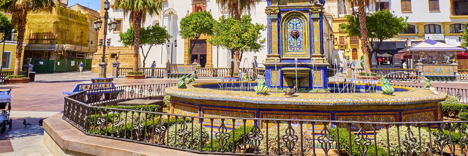 Algeciras, Spain - June 29, 2019. Plaza Alta Square of Algeciras, with the Nuestra Senora de la Palma Parish in the background and the monumental tiled fountain in the foreground. Algeciras, Cadiz province, Andalusia, Spain.