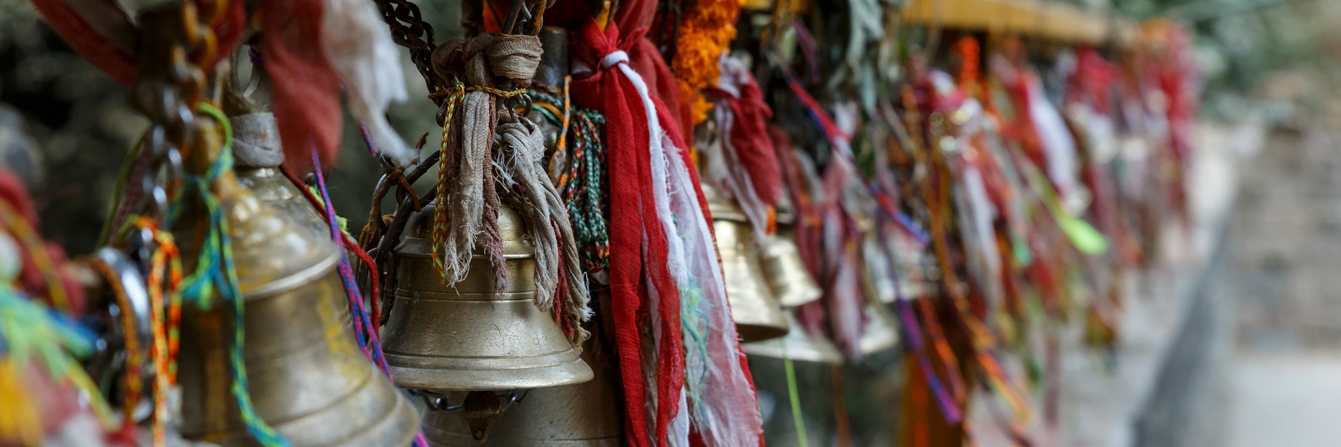 metal bells hang on chains in a Hindu temple. Dakshinkali Temple in Pharping, Nepal.