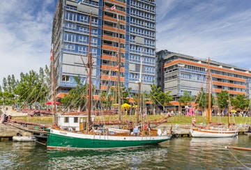 Old ships and modern buildings in the harbor of Kiel, Germany