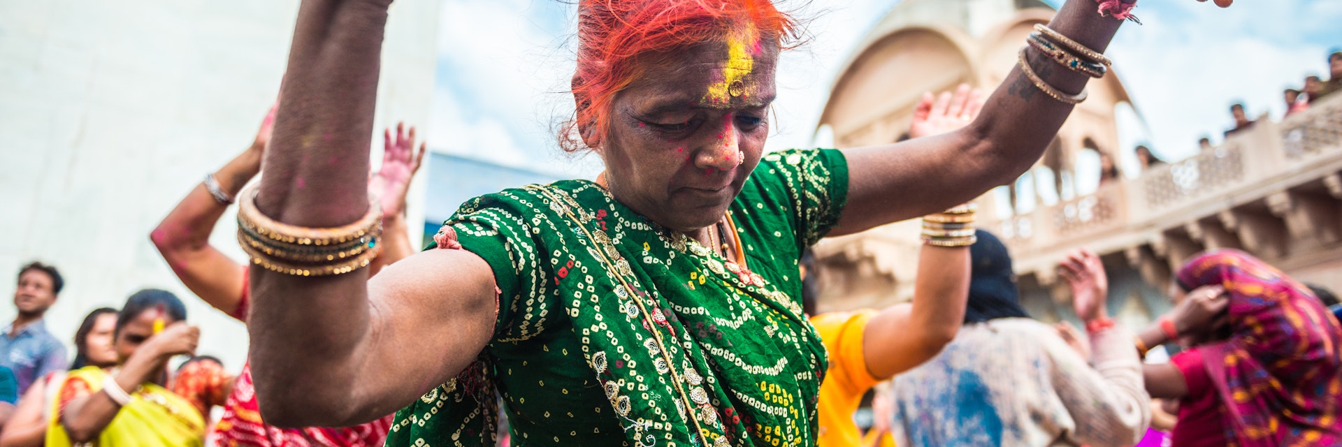 Barsana, India - March 10, 2014: Senior Indian woman celebrates Holi dancing in Radha Rani Temple in Barsana Village.