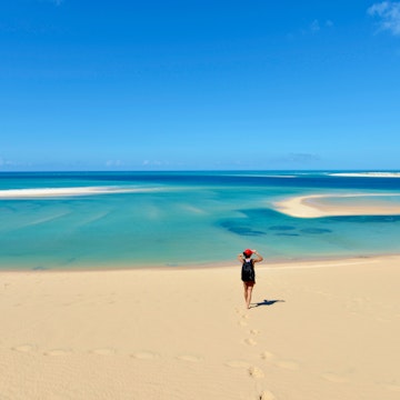 A young woman is in awe with spectacular views from Bazaruto Archipelago in Mozambique, East Africa.