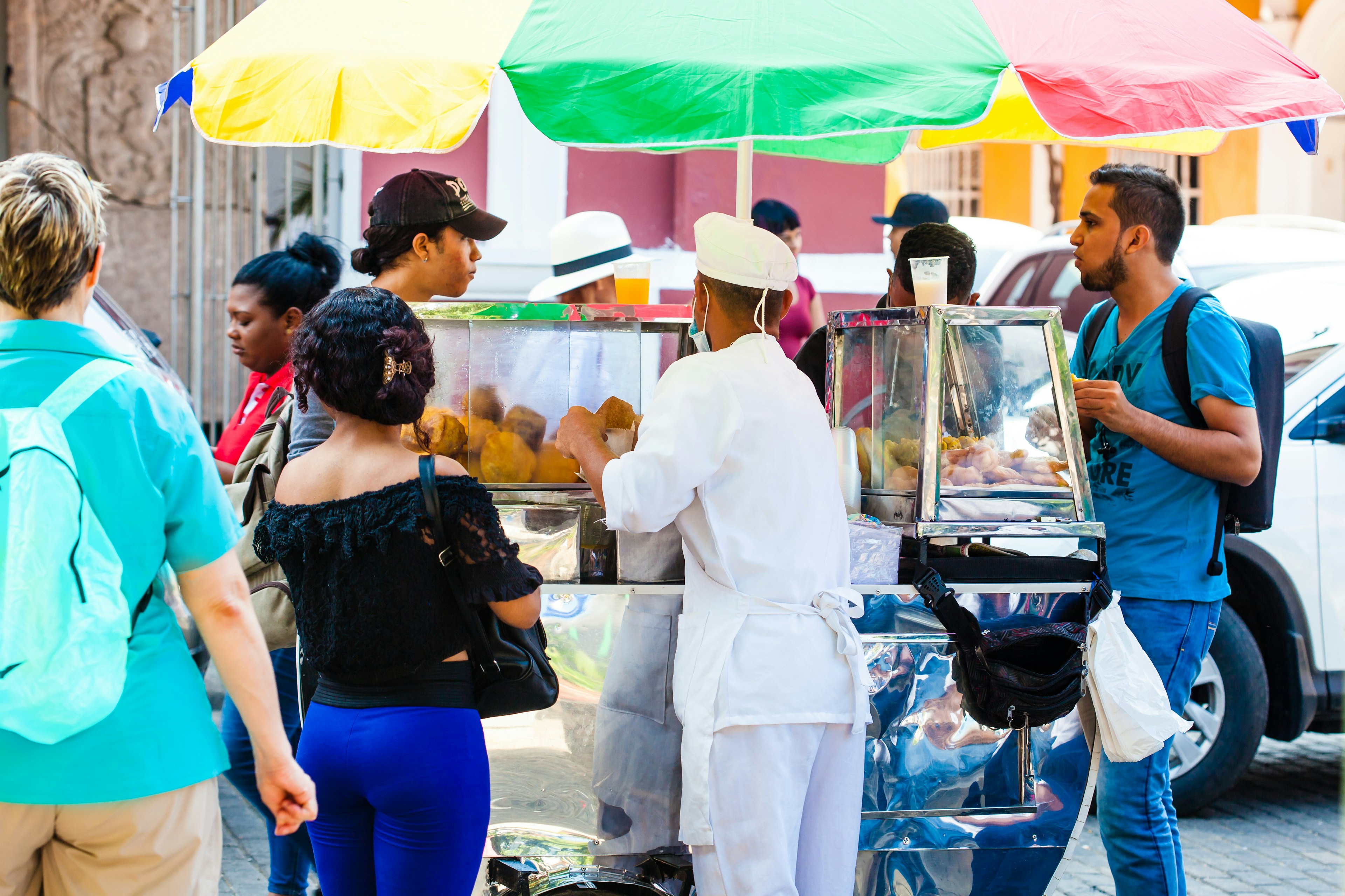 Woman selling fried street food at a stall in Cartagena