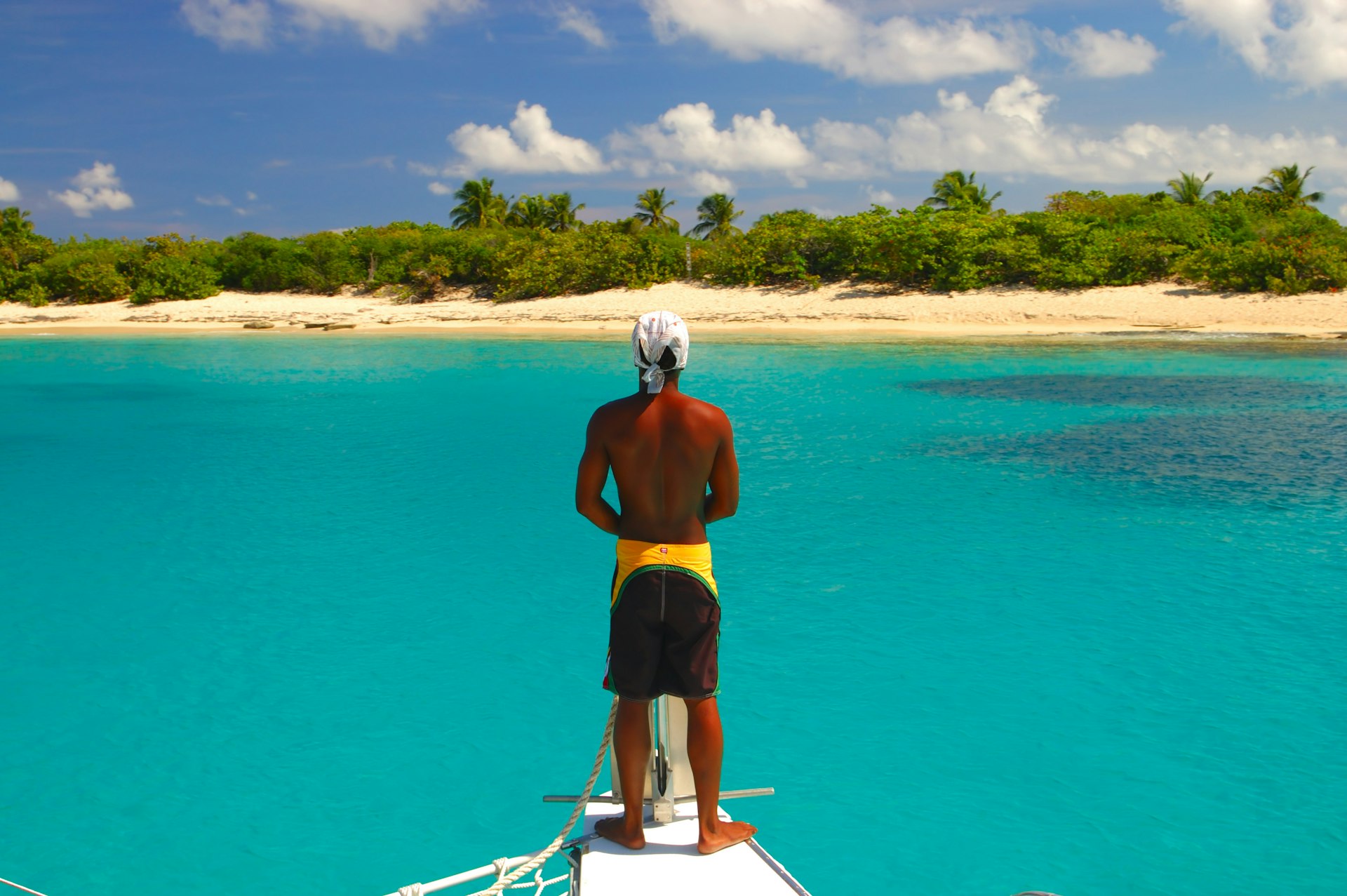 Man stands on a sail boat in Puerto Rico 