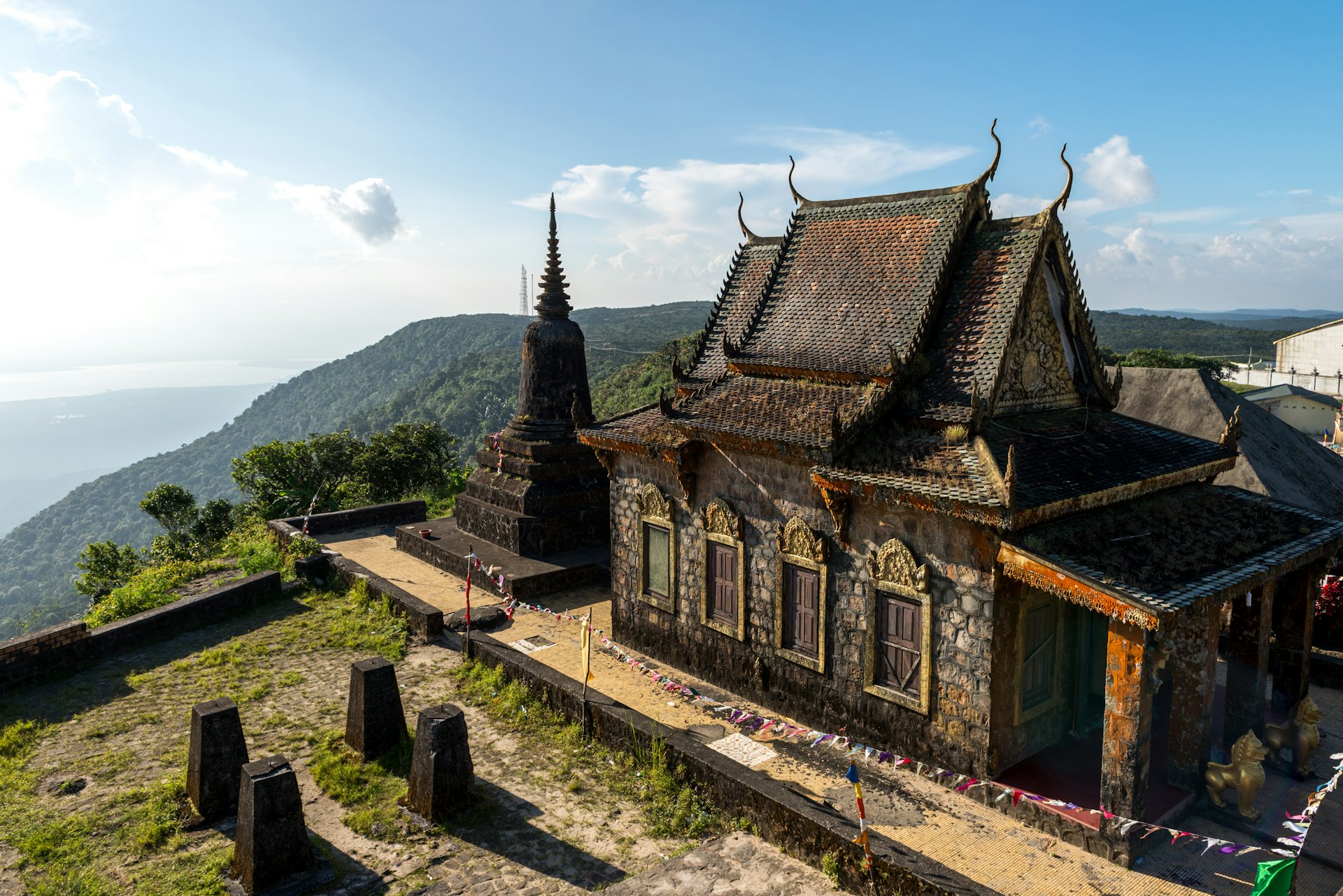 A Khmer temple at Bokor Hill Station in Cambodia, with view of sea beyond
