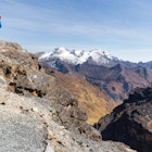 Two trekkers standing on the edge of a cliff on the El Choro trek.