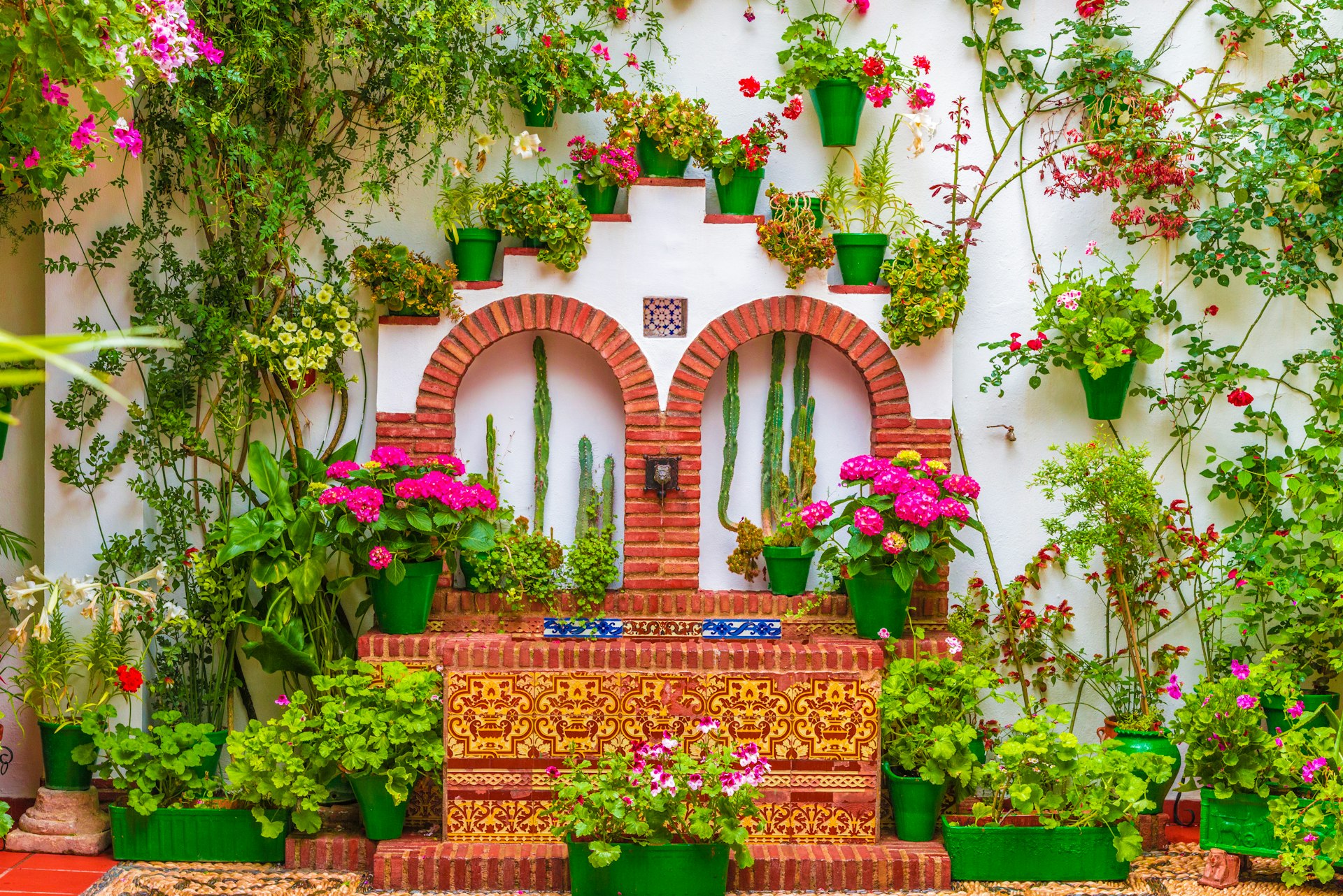 A traditional courtyard with flower pots on the wall in Cordoba.