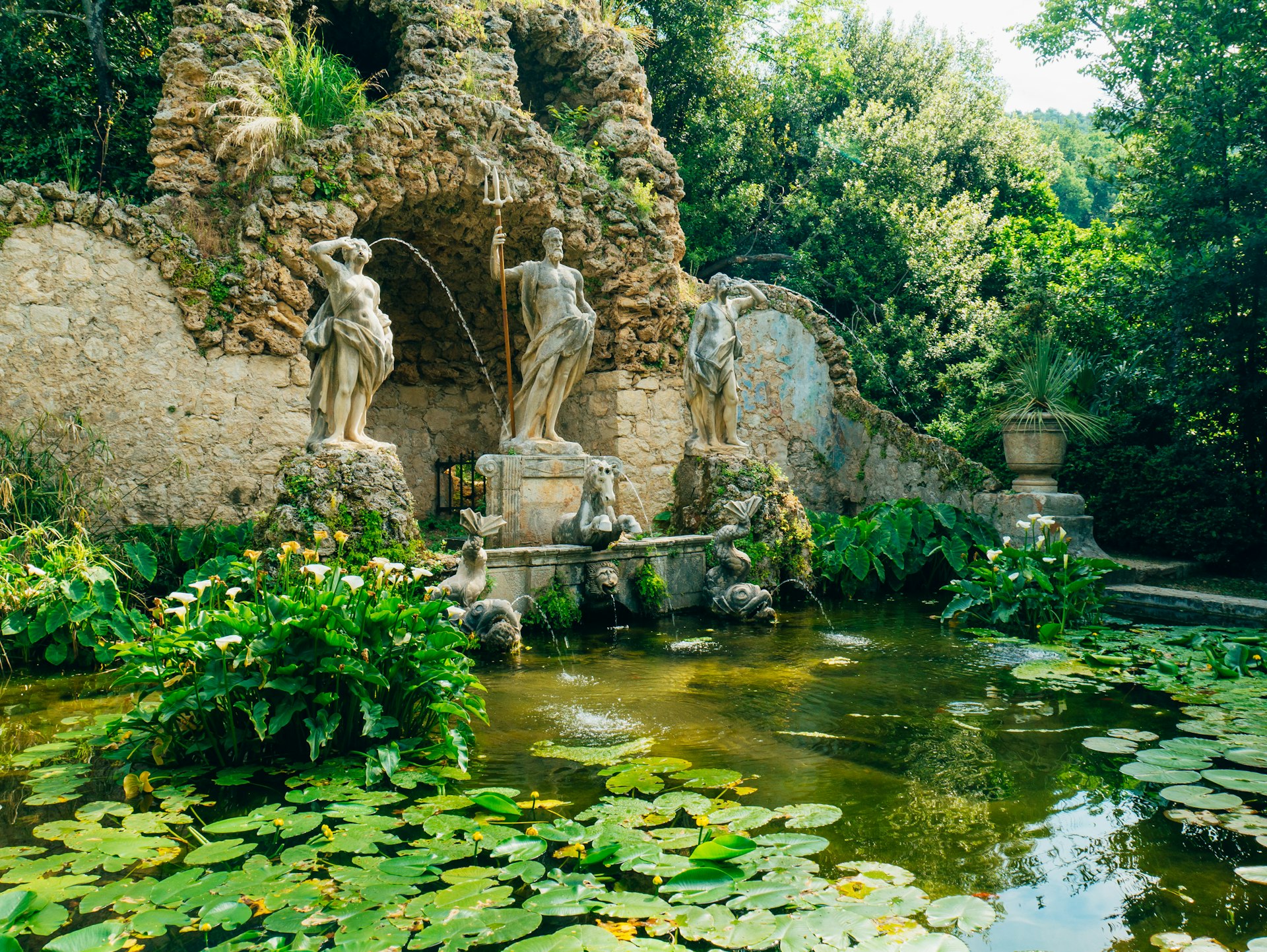 A fountain with waterlilies and a statue of Neptune at the Trsteno Arboretum