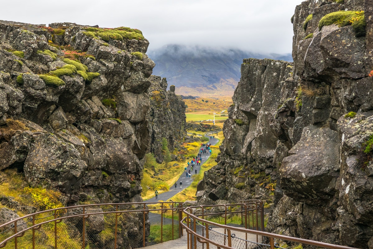Iceland - Thingvellir National Park, October, 10, 2014 - Beautiful view of people walking in the seam between the Eurasian and North American tectonic plates.