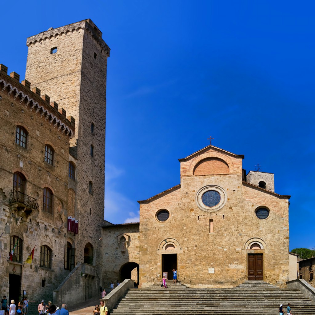 View Collegiate Church of Santa Maria Assunta in San Gimignano in the Duomo square. 16 June 2017 San Gimignano, Tuscany - Italy
