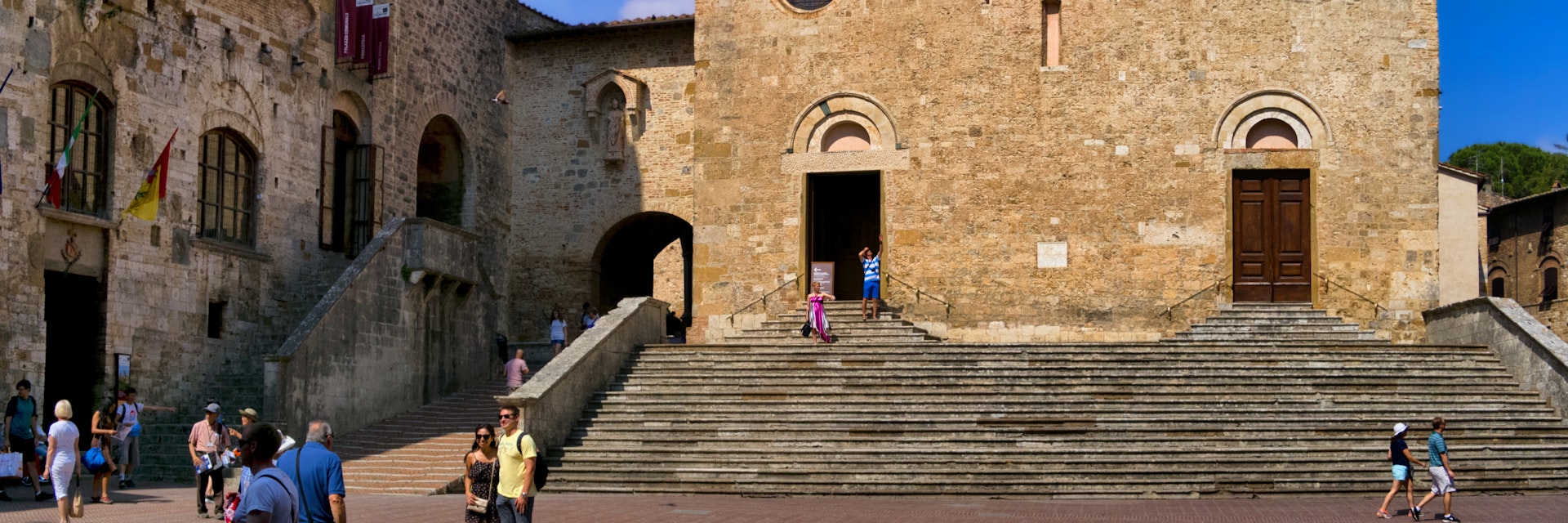 View Collegiate Church of Santa Maria Assunta in San Gimignano in the Duomo square. 16 June 2017 San Gimignano, Tuscany - Italy