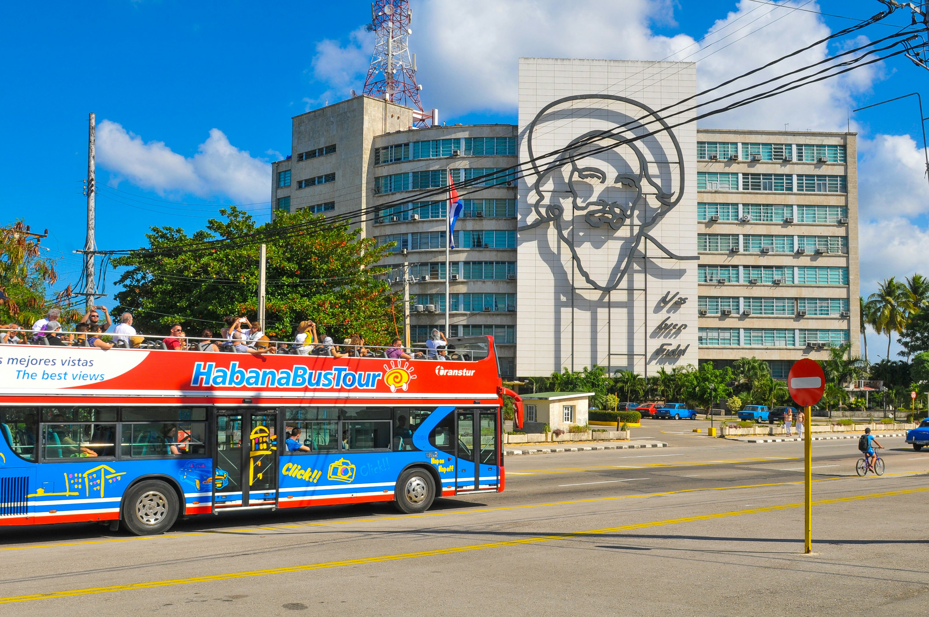 Blue-and-red sightseeing bus on a tour at Plaza de la Revolucion (Revolution Square) in Havana.