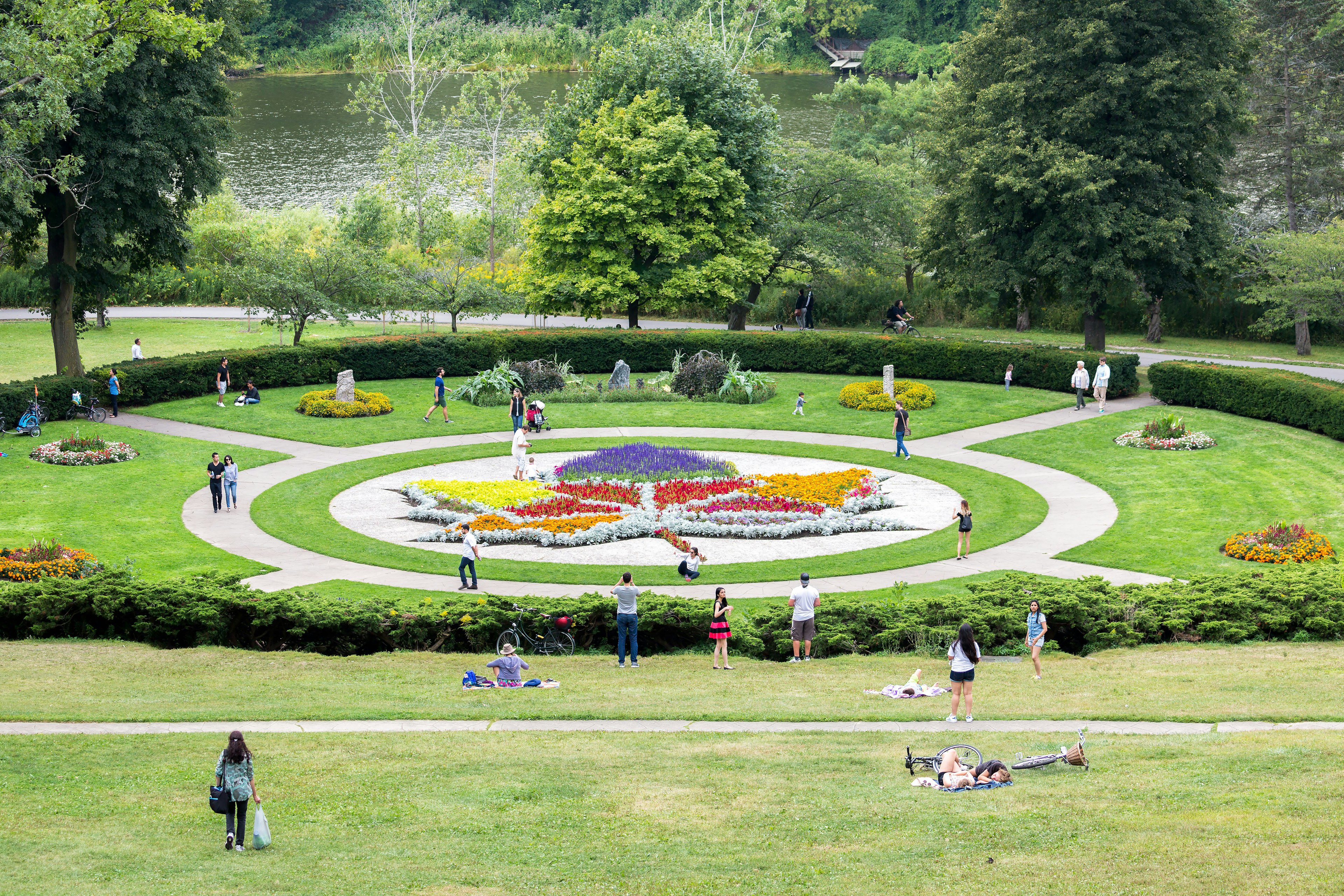 Visitors relax on the grass at the Maple Leaf Garden in High Park