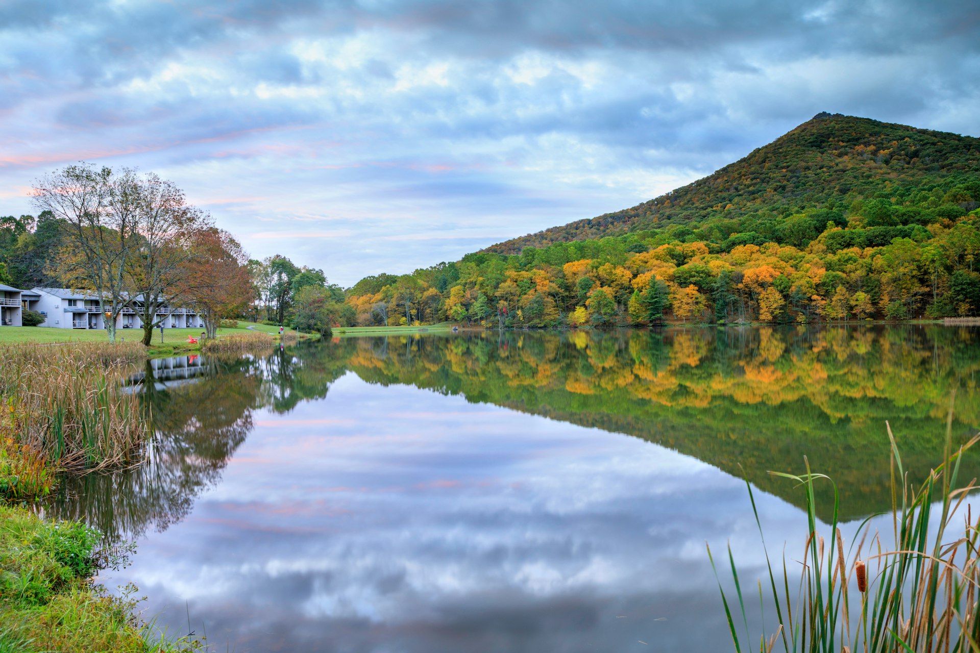 A reflective lake mirroring a nearby peak 