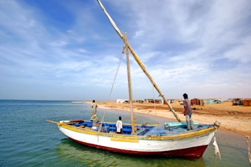 Coast of Banc d'Arguin National Park / Mauritania - photo taken December 01 / 2009 : boat with sails down and an fisher men onboard ; Shutterstock ID 1068303626; your: Erin Lenczycki; gl: 65050; netsuite: Online Editorial; full: Destination Update