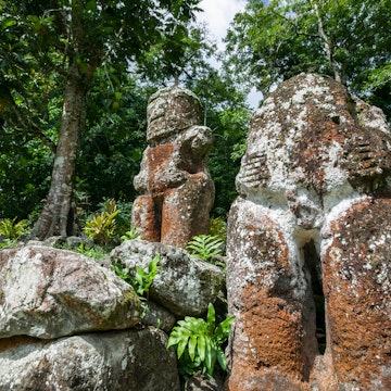 historic stone statues, so called Tikis, on Hiva Oa Island, Marquesas Islands, French Polynesia; Shutterstock ID 1108396337; your: Erin Lenczycki; gl: 65050; netsuite: Online Editorial; full: Destination
