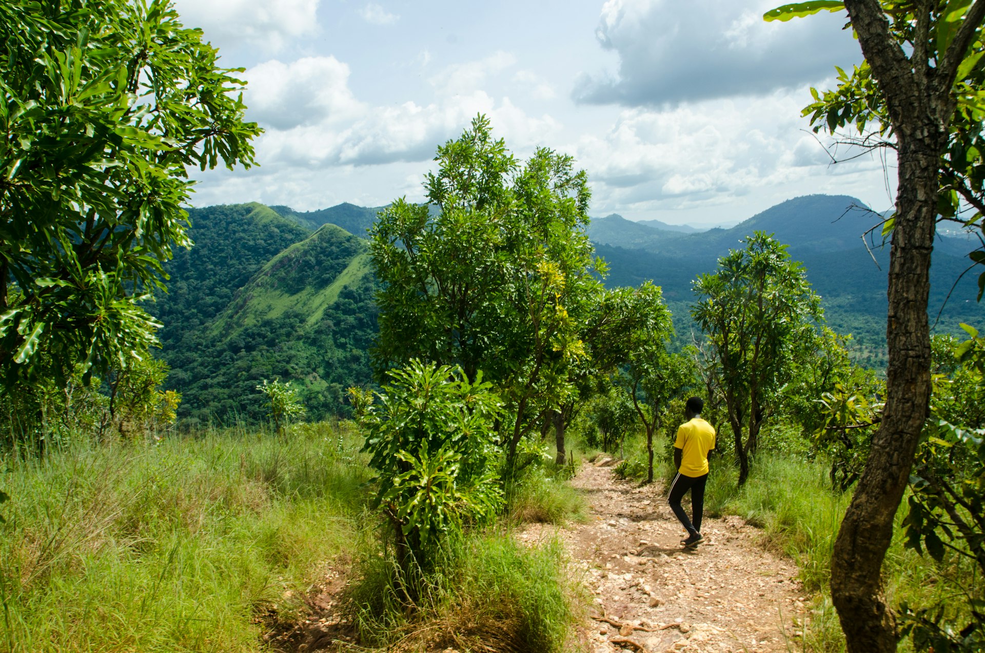 A man hikes on a local hiking mountain Afadjato, Volta Region, Ghana