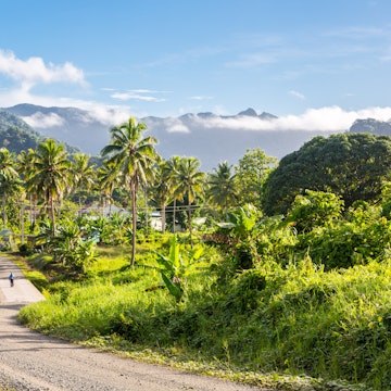 Volcanic hills, mountains, valleys, volcano mouth of beautiful green lush Ovalau island overgrown with palms, lost in jungle, covered with clouds, home of Levuka town. Fiji, Melanesia, Oceania. ; Shutterstock ID 1256221183; your: Erin Lenczycki; gl: 65050; netsuite: Online Editorial; full: Destination
