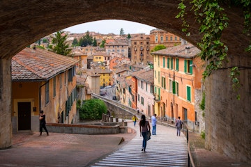 Perugia, Umbria / Italy - 2018/05/28: Panoramic view of the historic aqueduct forming Via dell Acquedotto pedestrian street along the ancient Via Appia street in Perugia historic quarter 