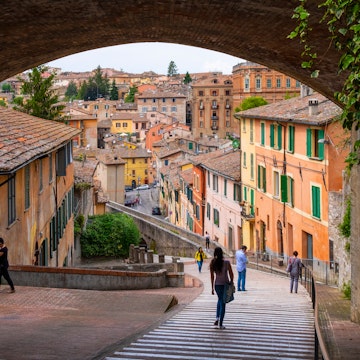 Perugia, Umbria / Italy - 2018/05/28: Panoramic view of the historic aqueduct forming Via dell Acquedotto pedestrian street along the ancient Via Appia street in Perugia historic quarter 
