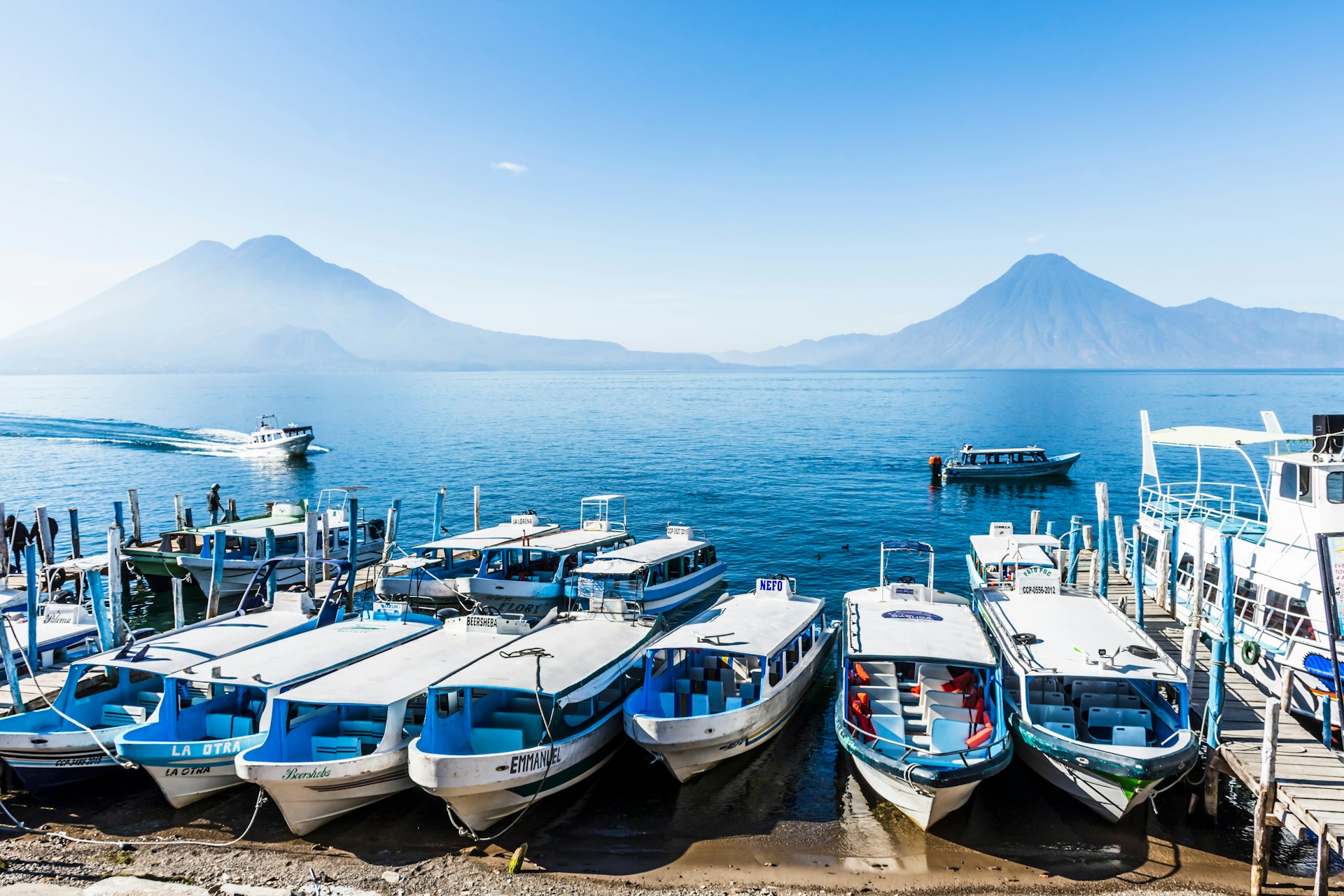 Ferry boats lined up on shore of Lake Atitlan, Guatemala