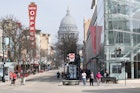 Madison, Wisconsin / USA - June 20, 2019: People Enjoying Shopping and Restaurants on State Street in Madison  Overlooking the Capitol Building and Dome on a Spring Day; Shutterstock ID 1469103266; your: Brian Healy; gl: 65050; netsuite: Lonely Planet Online Editorial; full: Best things to do in Madison