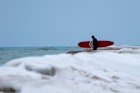 Sheboygan, Wisconsin, USA - January 10, 2018: Winter Surfing in Lake Michigan. The Malibu of the  Midwest freezes and doesn't stop visitors to the water for a new experience in fresh water surfing.; Shutterstock ID 1600796347; your: Brian Healy; gl: 65050; netsuite: Lonely Planet Online Editorial; full: Best beaches in Wisconsin
