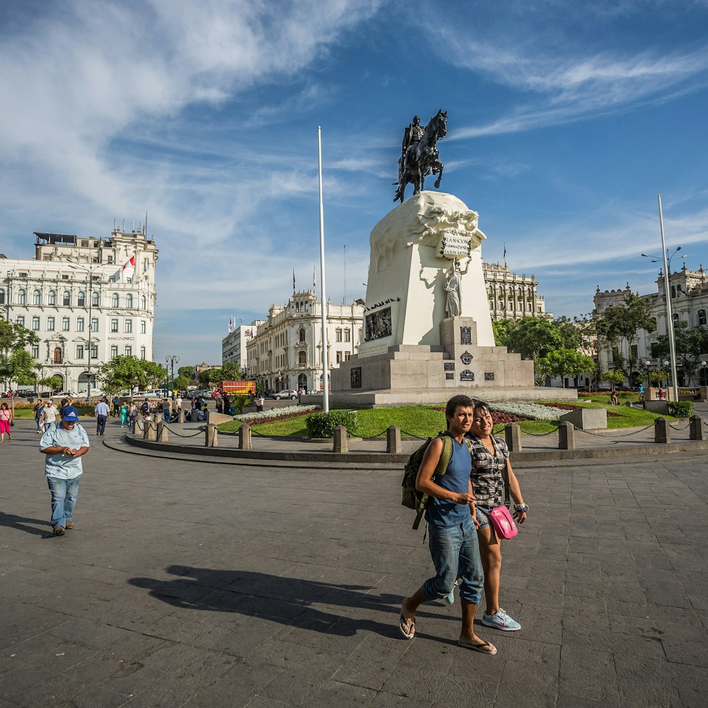 Pedestrians walk in the San Martin park in Lima, Peru