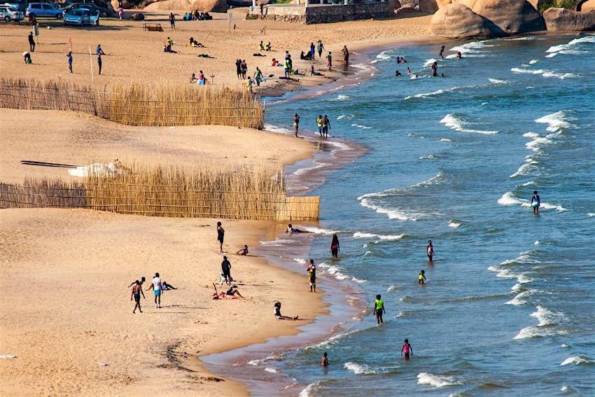 An aerial shot of crowds on the beach and in the water at Lake Malawi