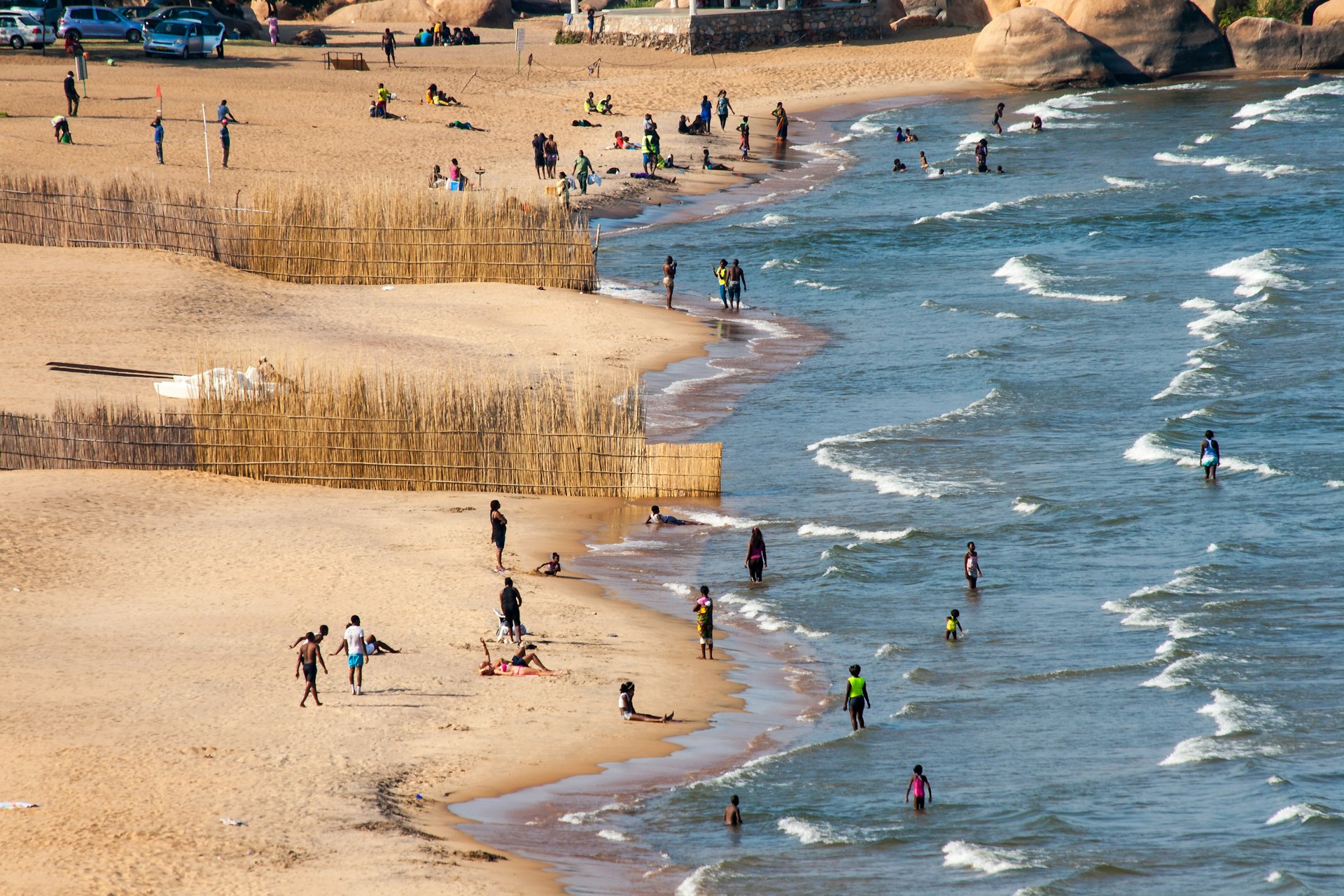 An aerial shot of crowds on the beach and in the water at Lake Malawi