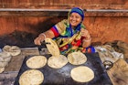 Indian street vendor preparing food - chapatti, flat bread, Jaipur - The Pink City, Rajasthan, India.  Jaipur is known as the Pink City, because of the color of the stone exclusively used for the construction of all the structures.