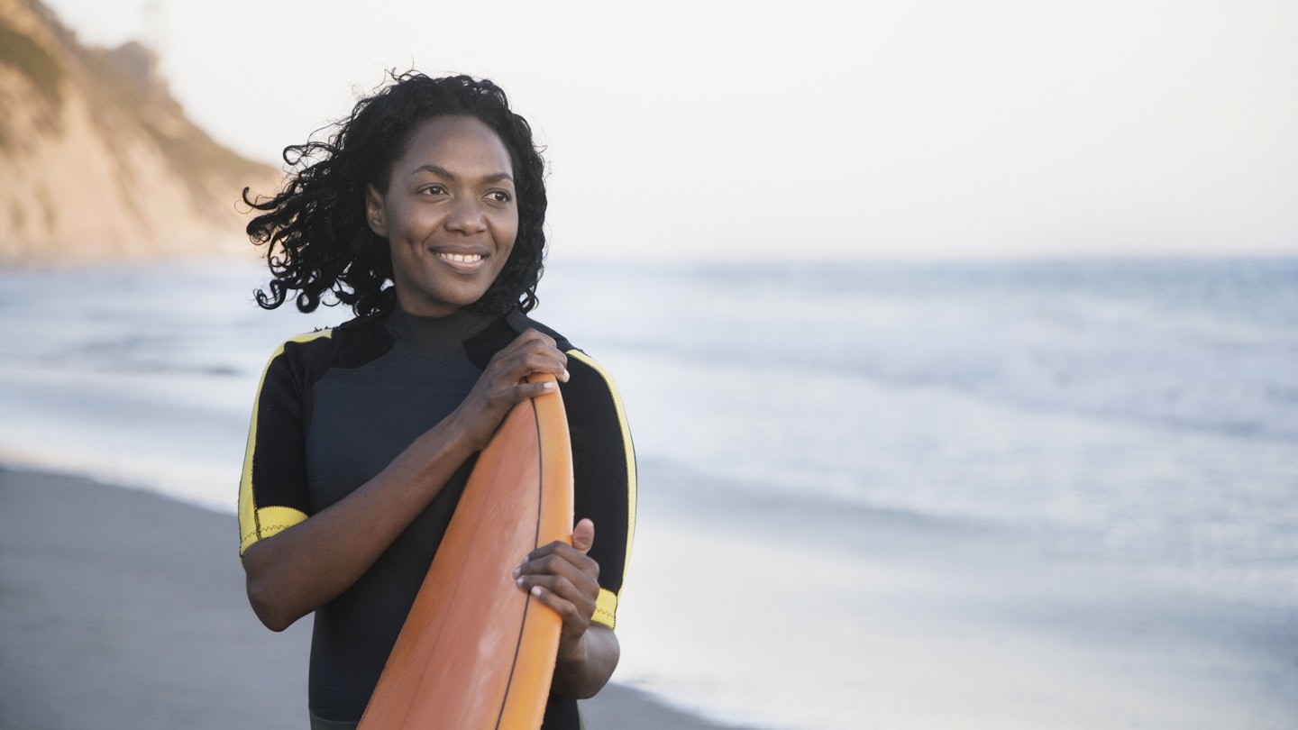 Woman holding surfboard in Santa Barbara