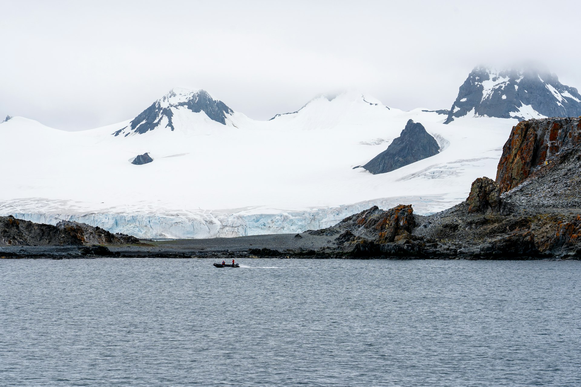 Boat driving past King George Island in Antartica.