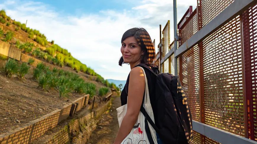 A woman looks at the camera on a walk through Monrovia Garden, Medellín, Antioquia, Colombia, South America