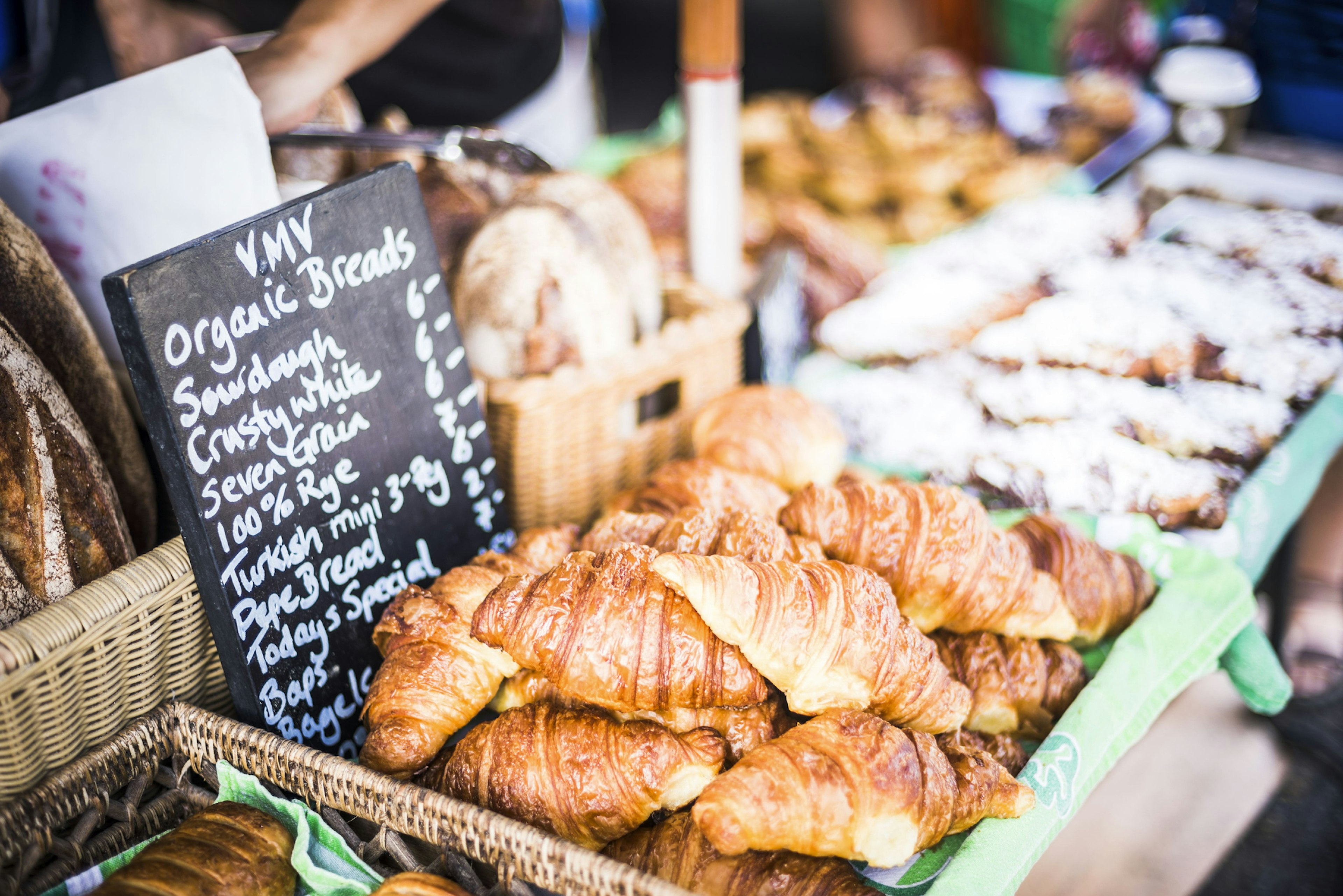 A range of baked goods arranged in baskets for sale at Punanga Nui Market, Cook Islands