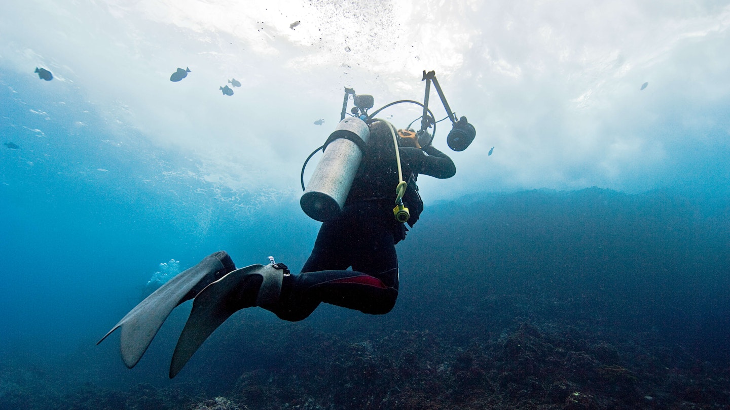 The underwater world of Cocos Island - scuba diver taking underwater pictures