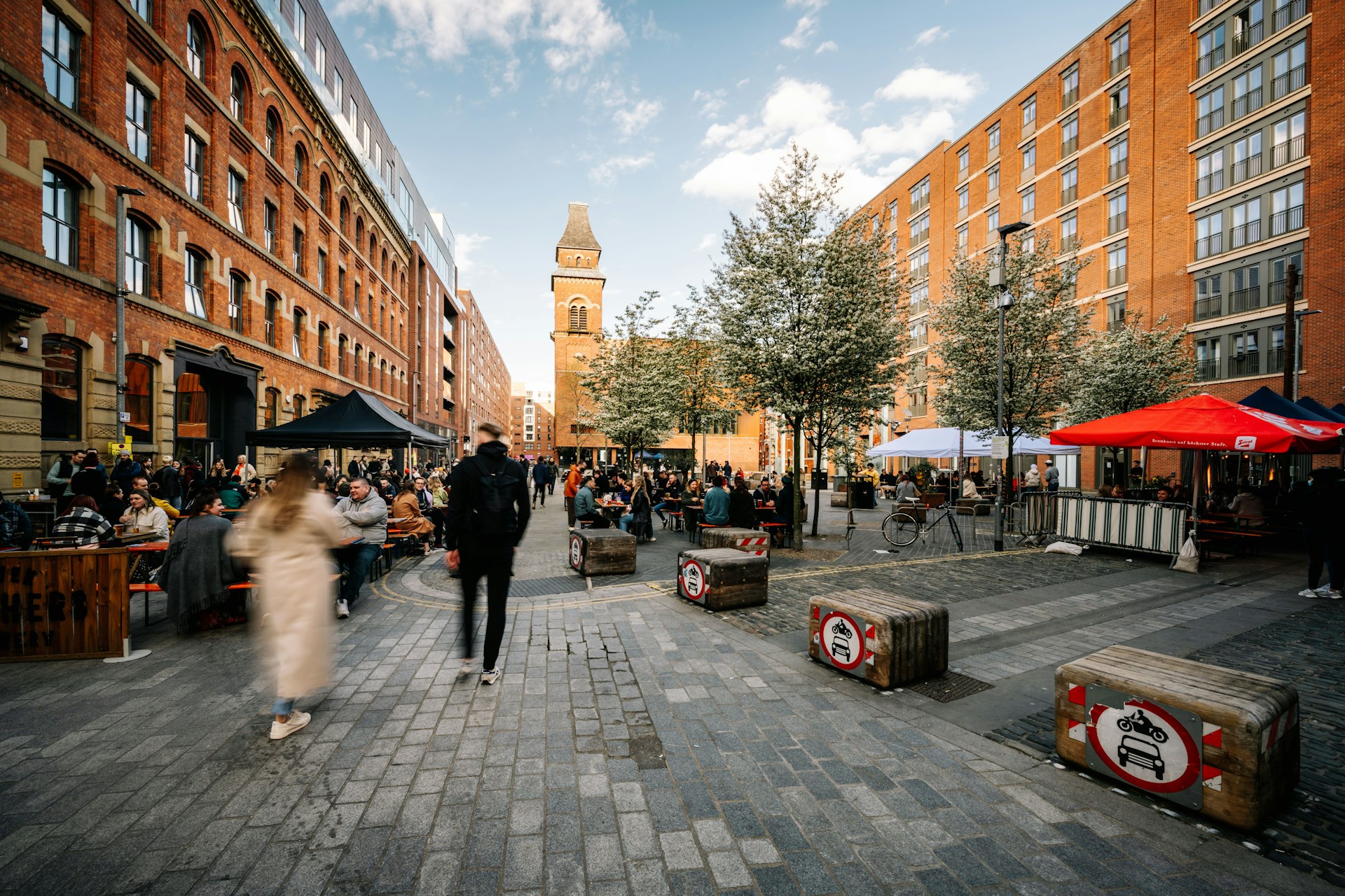 People walking through Cutting Room Square in the Ancoats neighborhood of Manchester, England